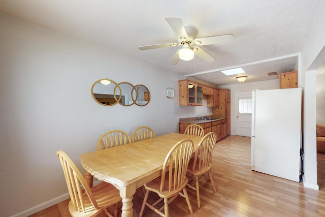 dining space with light hardwood / wood-style floors, ceiling fan, a textured ceiling, and sink