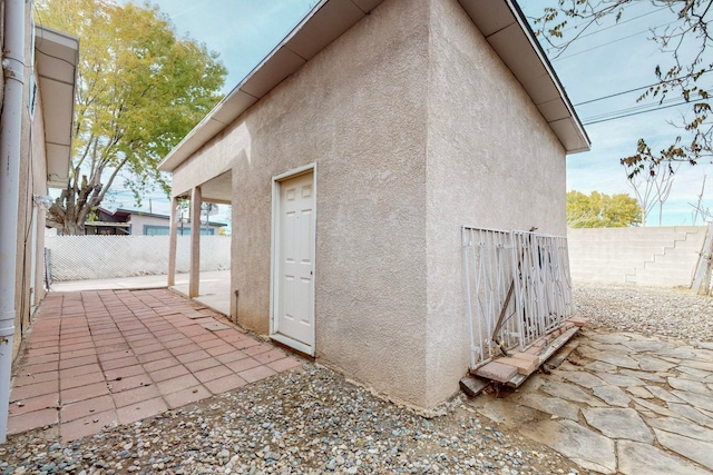 view of property exterior with a patio area