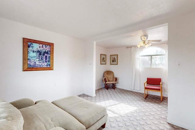 living room with light colored carpet and ceiling fan