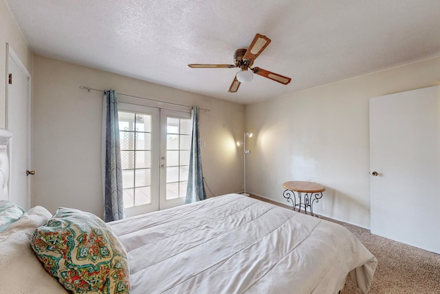 bedroom with ceiling fan, a textured ceiling, carpet flooring, and french doors