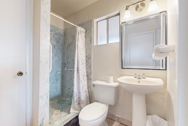 bathroom featuring sink, tile patterned floors, curtained shower, and toilet