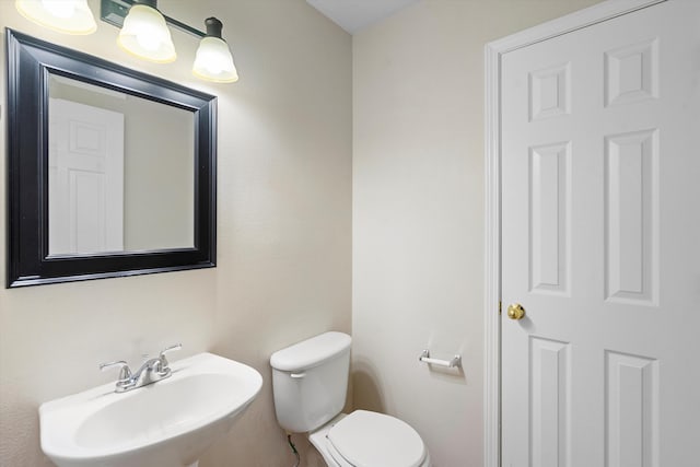 bathroom with toilet and sink