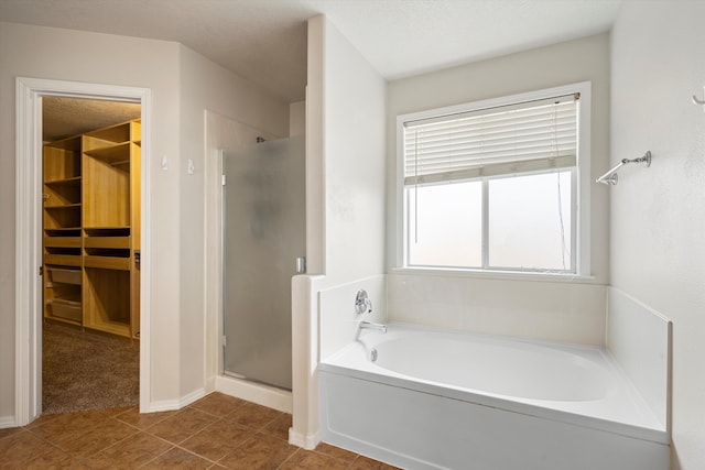 bathroom with tile patterned flooring and independent shower and bath