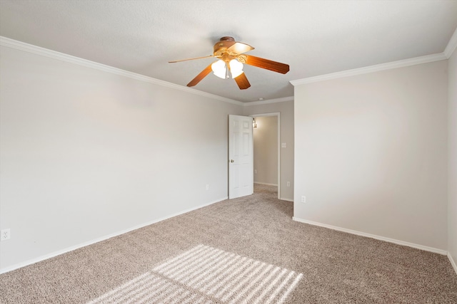 carpeted empty room with ceiling fan and ornamental molding