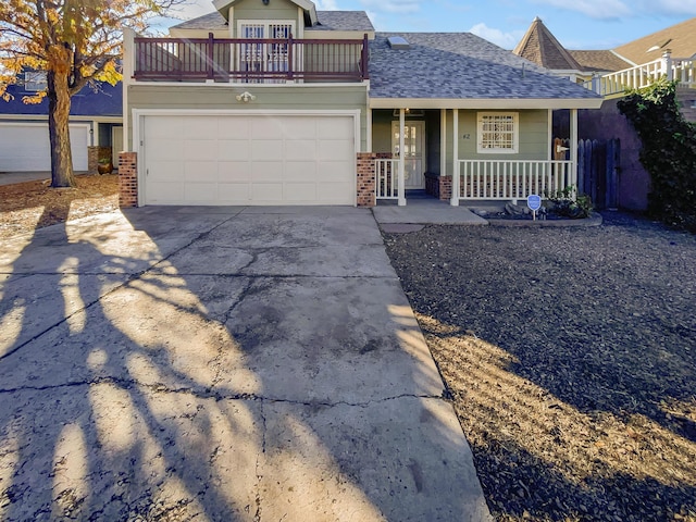 view of front of home featuring a porch, a balcony, and a garage