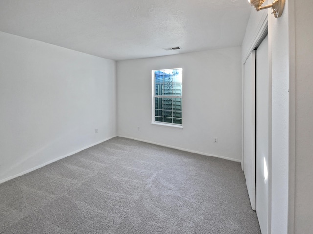 unfurnished bedroom with carpet flooring and a textured ceiling