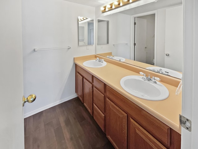 bathroom with hardwood / wood-style floors, vanity, and toilet