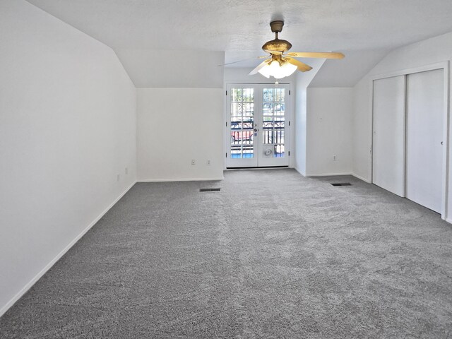 additional living space featuring ceiling fan, french doors, carpet, and lofted ceiling