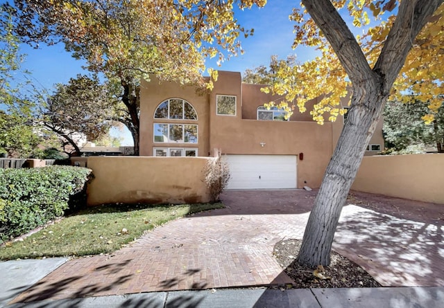 pueblo-style home with a garage