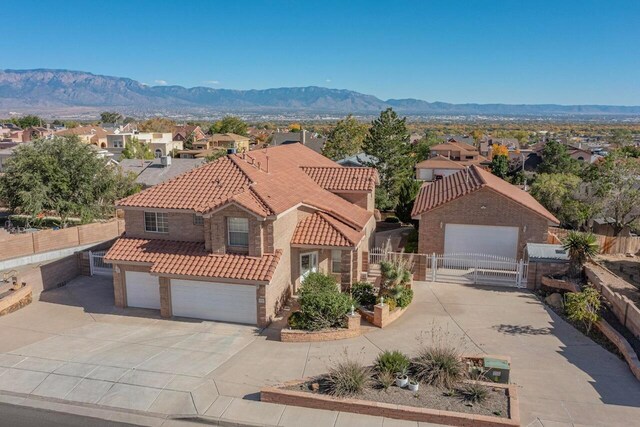 mediterranean / spanish-style home featuring a garage and a mountain view