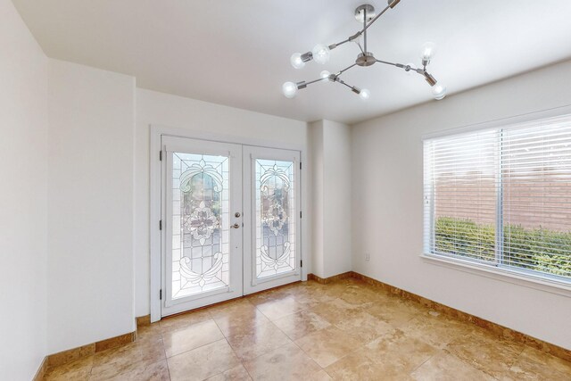 interior space with an inviting chandelier and french doors