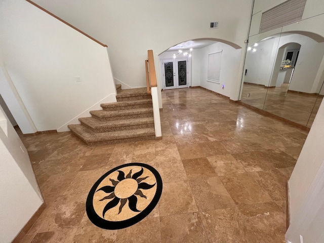 entryway with a high ceiling and french doors