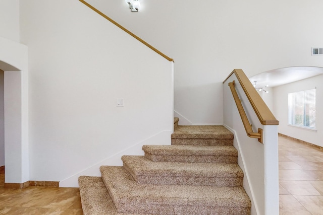 stairs with tile patterned floors