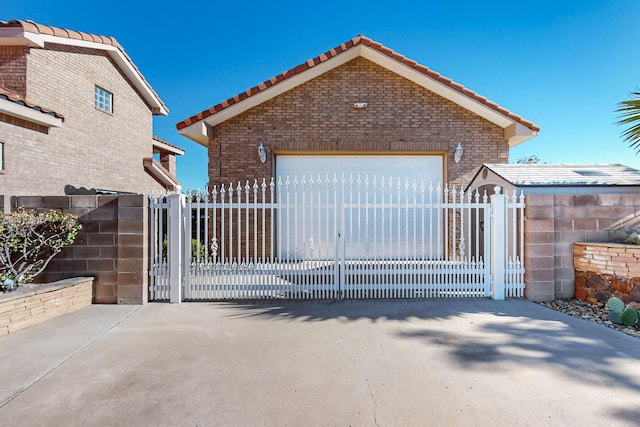 view of gate featuring a garage