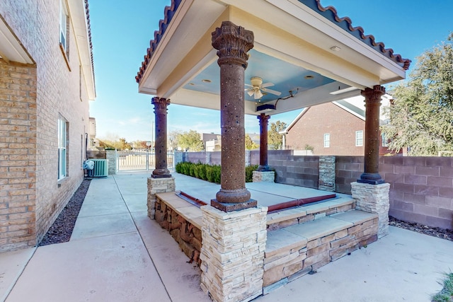 view of patio featuring cooling unit, ceiling fan, and exterior bar