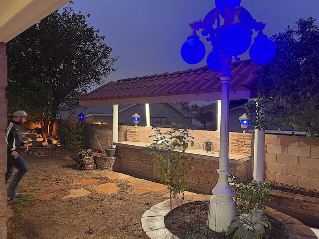 view of patio featuring ceiling fan, area for grilling, and a jacuzzi