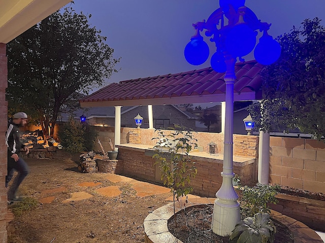 patio terrace at dusk featuring a pergola