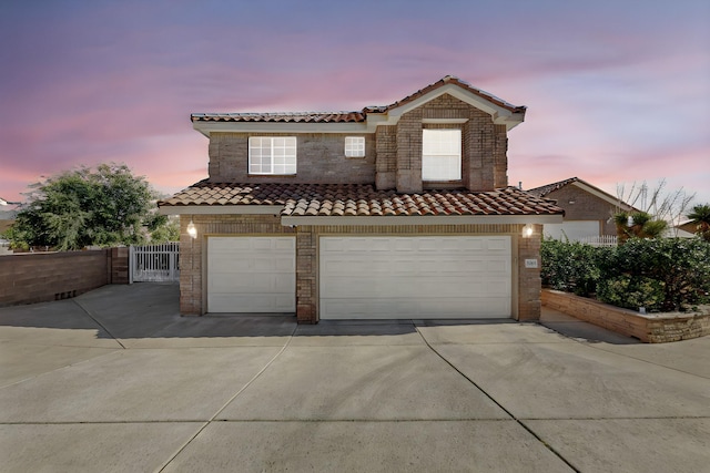 mediterranean / spanish-style home with a garage