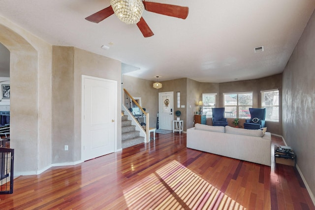 living room featuring dark hardwood / wood-style floors and ceiling fan