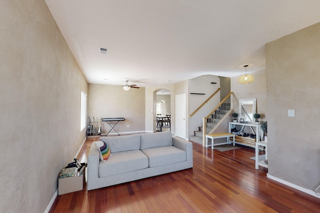 living room featuring hardwood / wood-style floors and ceiling fan