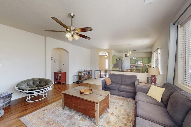 living room featuring ceiling fan and light hardwood / wood-style flooring