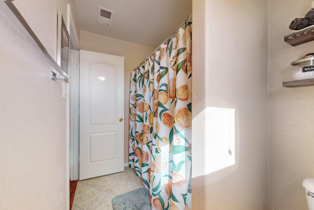 bathroom with tile patterned floors