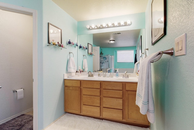 bathroom featuring a shower with door and vanity