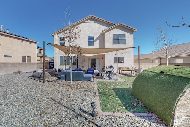 rear view of house featuring an outdoor living space, a patio, and a lawn