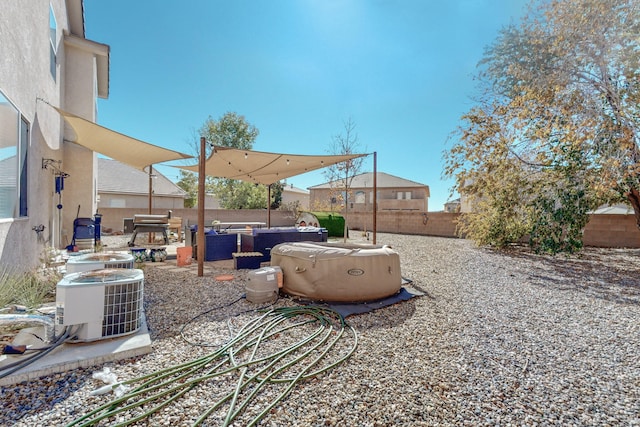 view of yard featuring a hot tub, a patio area, outdoor lounge area, and central air condition unit