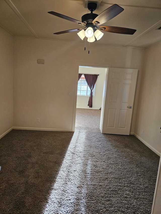 carpeted spare room featuring ceiling fan