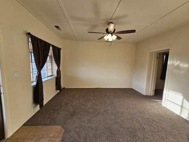 carpeted spare room with ceiling fan