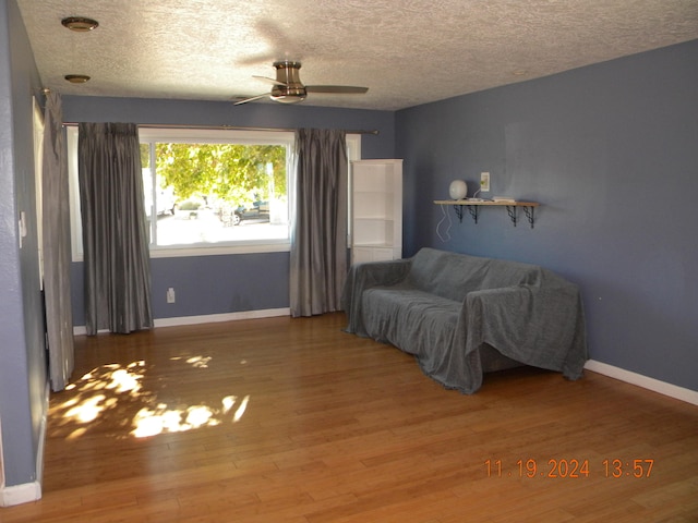 unfurnished room featuring ceiling fan, hardwood / wood-style floors, and a textured ceiling