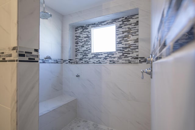 full bath with tiled shower