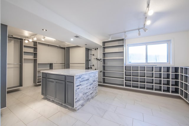 spacious closet featuring visible vents