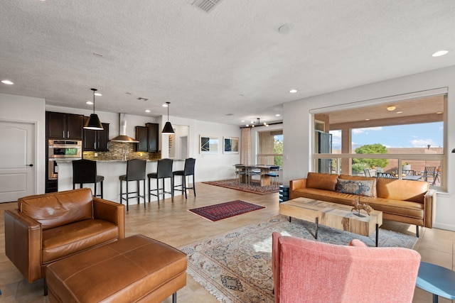 tiled living room featuring a textured ceiling