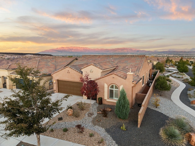 view of front of house with a mountain view and a garage