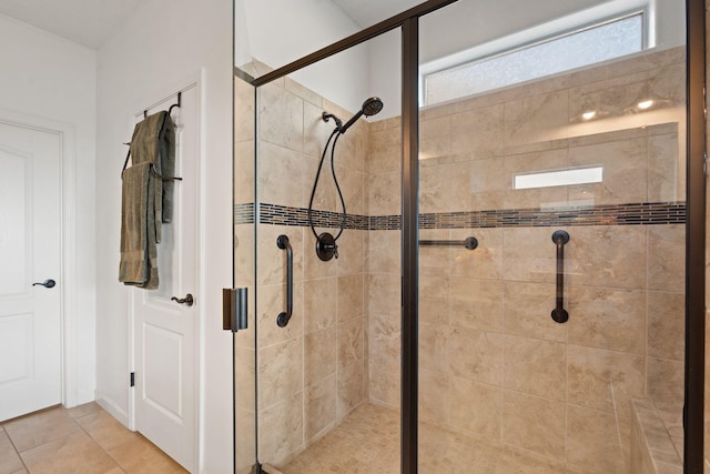 bathroom featuring tile patterned floors and a shower with door