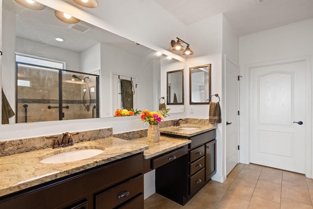 bathroom with tile patterned flooring, vanity, and an enclosed shower