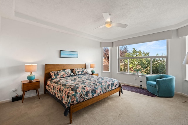 carpeted bedroom featuring a textured ceiling and ceiling fan