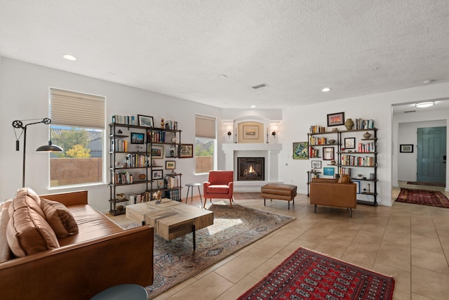 tiled living room with plenty of natural light and a textured ceiling