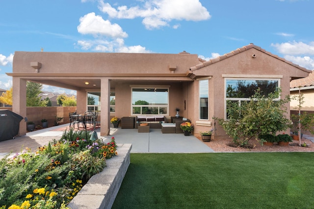 back of house with a yard, a patio, and an outdoor hangout area