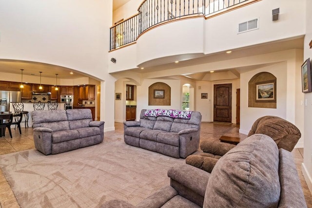 tiled living room with a towering ceiling