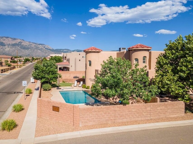 view of swimming pool featuring a mountain view and a patio