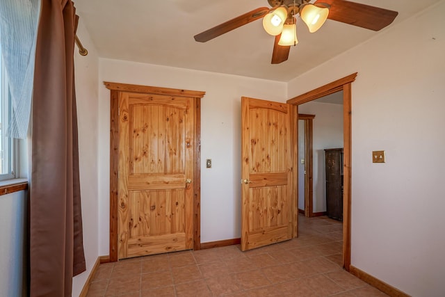 unfurnished bedroom featuring ceiling fan and light tile patterned floors