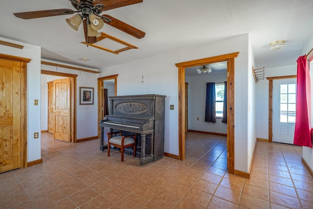 misc room with light tile patterned floors and ceiling fan