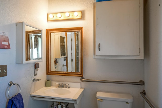 bathroom featuring toilet and sink