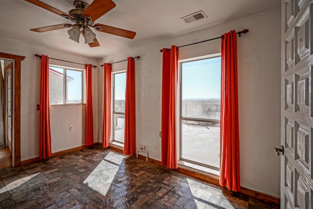 interior space with ceiling fan