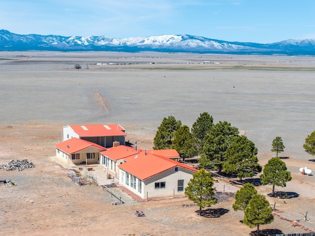 drone / aerial view with a water and mountain view