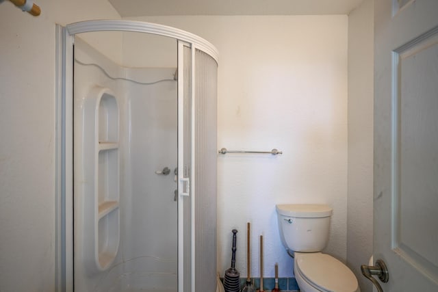 bathroom featuring toilet and walk in shower