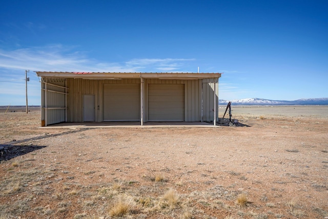 view of outbuilding with a mountain view and a garage